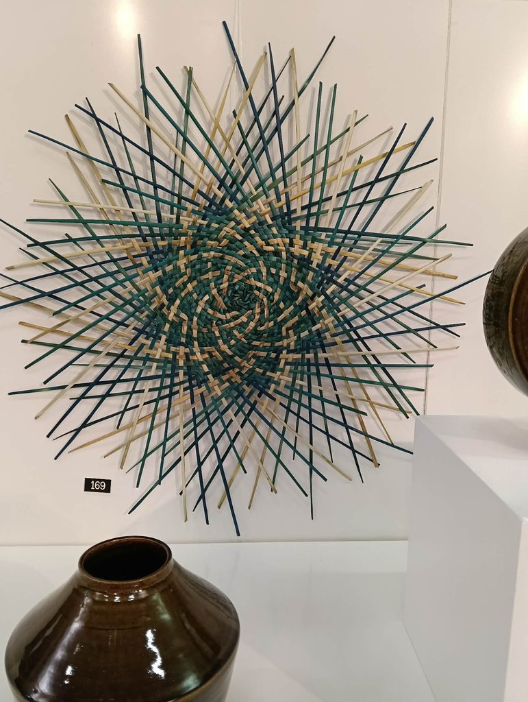 Woven harakeke Sunburst artwork made with dyed and natural fibres for the Riversdale Arts Exhibition.